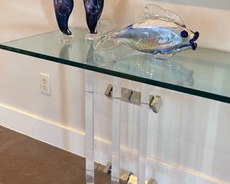 After Charles Hollis Jones Post Modern Acrylic/Lucite and glass console table. Beautiful, thick “skyscraper” lucite base with metal detail and 3/4 inch glass top. 82x18x22.5 inches.