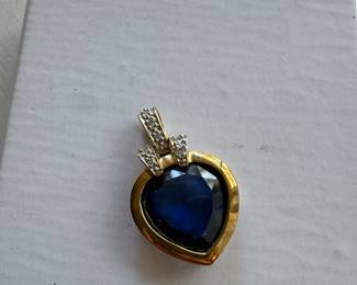 $150- 10kt gold heard pendant with Sapphire style stone. 