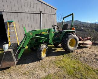 Tractor includes lawnmower, chipper and sprayer.