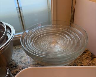 A glass set of bowls the set is complete from very large to very small