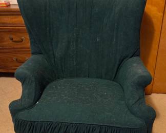 Dark Green Upholstered Wingback Chair with Ruffled Skirt