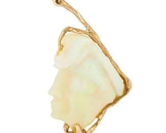 1053
A 14K Gold and Opal Pendant
Of an organic design featuring a carved opal of a woman's profile measuring approximately 40.00 x 30.00 x 6.27 mm

Measures: 2 1/2 X 1 1/4 in.
16.0 grams gross
Estimate: $1,500 - $2,000