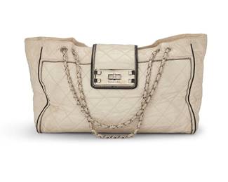 1160
CHANEL: A Mademoiselle Lock East West Lambskin Bag, 2008
Circa 2008; Italy
Marked to interior: Chanel / ® / Made in Italy; Carte D'Authenticité and interior tag: No. 12122653
A large tote bag in smooth off white leather with diagonal matelasse quilting, featuring contrast edges of black piping and zigzag stitching, with wide flap closure with a large turn-lock clasp, silver-toned metal hardware, leather chain handles, and fully lined in beige satin fabric, with multiple interior pockets, and a matching leather key fob strap, with original box and dust bag
11 x 16.5 x 6 in. / 28 x 42 x 15 cm; handle drop: 9.5 - 15.5 in/ 24 - 39 cm
Estimate: $700 - $900