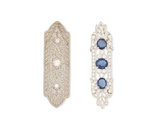 1076
3Two 14K White Gold, Silver, Diamond and Sapphire Pendants
Including a rhodium plated silver pendant set with three oval sapphires accented by round diamonds weighing approximately 1.00 carat, together with a 14k white gold and diamond set open work motif pendant
2 pieces

Measures: 2 in.
9.5 grams gross
Estimate: $400 - $600