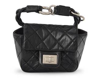 1161
CHANEL: A Black Mini 2.55 Anklet Bag, 2008
Circa 2008; France
Marked to interior: Chanel / CC / Made in France; With interior tag: No 12010194
The anklet in diagonally quilted smooth black leather with silver toned magnetic Mademoiselle clasp and hardware
3 x 3.5 x 2 in. / 7.5 x 9 x 5 cm; strap: 10 in. / 25.5 cm
Estimate: $400 - $600