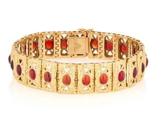 1008
An 18K Gold and Glass Bracelet
Featuring ornate frame style links centering oval red glass cabochons, signed Brevettato with Italian assay marks

Length: 7 1/ in., Width:1/2 in.
30.4 grams gross
Estimate: $800 - $1,200