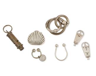 1171
A Group of Sterling Silver Accessory Items Including Tiffany & Co.
Featuring four Tiffany & Co. sterling silver items including an interlocking three-ring rattle, a diminutive silver shell pill box, and two sterling silver valet key rings, as well as a small sterling silver key ring with monogram charm, and two further mixed metal key rings, one with a whistle, four marked for Tiffany & Co., and three for sterling
7 pieces

Largest: 3 1/2 in. x 2 in.; smallest: 2 in. x 1 in.
Sterling: 122.0 grams gross
Estimate: $200 - $300