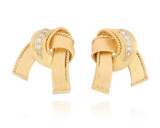 1131
A Pair of 14K Gold and Diamond Earclips
Of a bow design with rope accents, set with round diamonds weighing approximately 0.26 carats
2 pieces

Measures: 7/8 x 3/4 in.
10.6 grams gross
Estimate: $600 - $800