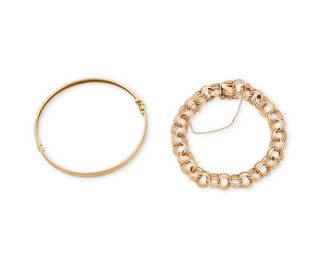 1133
Two 14K Gold Bracelets
Featuring a double round link bracelet together with an etched hinged bangle

Measures: 7 1/4 in.
23.2 grams gross
Estimate: $1,000 - $2,000