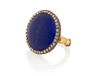 1084
A Bi-Color Gold, Lapis Lazuli and Diamond Ring
Centering a round lapis lazuli cabochon measuring approximately 22.00 x 22.00 x 3.78 mm, encircled by rose-cut diamonds

Size: 7
11.4 grams gross
Estimate: $1,000 - $1,500
