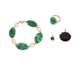 1036
A Group of 14K Gold and Jade Jewelry
Including a carved jade bracelet, two pendants, one of a small carved jade disc and one of a carved black jade shell, together with an oval jade cabochon ring
4 pieces

Ring: 6, Bracelet: 7 1/2 in., Pendants: 1/2 in. and 1 1/8 in.
18.7 grams gross
Estimate: $600 - $800