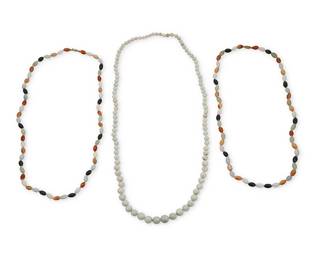 1038
Three Jade Bead Necklaces
Including a single graduated strand of green jade beads measuring 7.3 - 13.3 mm, together with two marquise-shaped bead necklaces featuring red, orange, black and green jade
3 pieces

Lengths: 30 1/2 - 36 in.
266.3 grams gross
Estimate: $400 - $600
