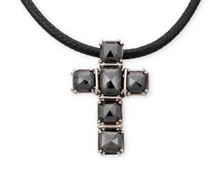 1075
An 14K White Gold and Black Diamond Necklace
Featuring a braided black corn suspending a white gold and six top faceted black diamonds cross pendant

Length: 18 in., Pendant: 1 1/2 x 1 in.
12.6 grams gross
Estimate: $500 - $700
