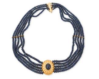 1045
A Gold, Sapphire and Diamond Necklace
Featuring five strands of graduated sapphire beads measuring approximately 2.9 - 4.6 mm, centering a scalloped center element featuring an oval sapphire measuring approximately 11.67 x 9.52 x 6.50mm, encircled by round diamonds

Length: 14 in.
67.2 grams gross
Estimate: $2,500 - $3,500