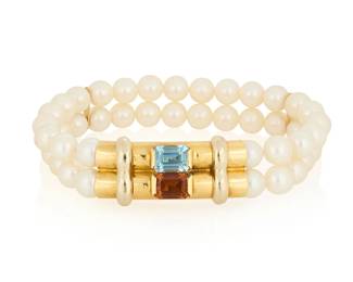 1125
An 18K Gold, Cultured Pearl, Citrine and Topaz Bracelet
Featuring two strands of cultured pearls measuring approximately 6.85-6.90mm, centering an emerald-cut citrine and blue topaz, with Italian marks

Measures: 7 in.
31.9 grams gross
Estimate: $700 - $1,000