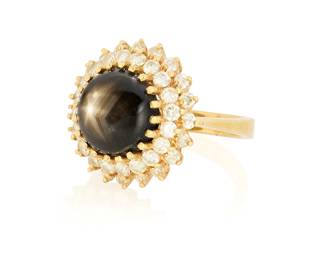 1136
A 14K Gold, Black Star Sapphire and Diamond Ring
Centering a black star sapphire measuring approximately 9.85 x 9.85 mm, encircled by two rows of round diamonds weighing approximately 0.80 carat

Size: 5
7.1 grams gross
Estimate: $700 - $1,000