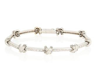 1022
A 18K White Gold and Diamond Bracelet
Featuring bar style links accented by an "X" design, all set with round diamonds weighing approximately 0.85 carat

Length: 7 1/2 in.
11.6 grams gross
Estimate: $800 - $1,200