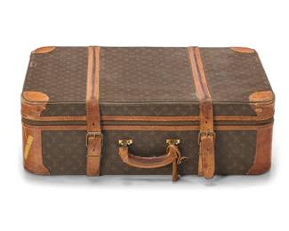 1165
Louis Vuitton: A Vintage Monogram Canvas Trunk Suitcase, 1984
20th century, France
Marked to leather on base: ® / Louis Vuitton / Paris / made in france; numbered to strap verso: 842
A large trunk in LV coated canvas with leather trim and handle, with LV branded brass zipper pulls and two wide buckled straps, the interior lined with pale yellow cotton and including two branded straps; with associated LV luggage tag

20 3/4 x 31 x 10 in.; handle drop: 2 1/4 in. / 52.7 x 78.8 x 25.5 cm; handle drop: 5.7 cm
Estimate: $400 - $600