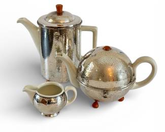 Vintage German Art Deco tea and coffee set from the 1920's. Silver-plated thermal "cozies" with porcelain liners and Bakelite knobs and feet.