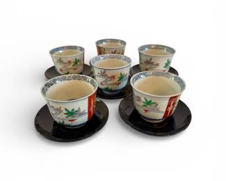 Antique Imari cups on wooden saucers