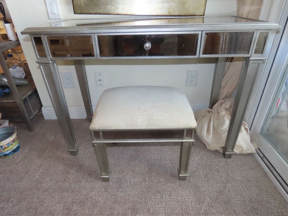 Mirrored dressing table and padded stool.