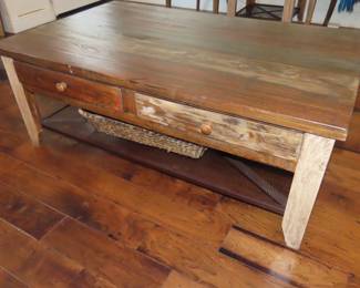 Distressed wood coffee table with drawers.