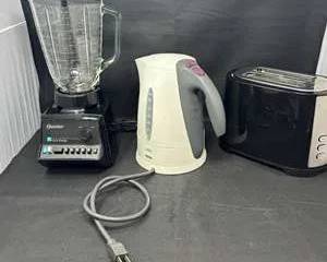 Lot 33  Kitchen Countertop Appliance Lot  Osterizer Blender, Braun Electric Kettle  Hamilton Beach Toaster