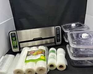 Lot 32  FoodSaver Automatic Vacuum Sealer with Bag Rolls  Vacuum Containers  Complete Food Storage System