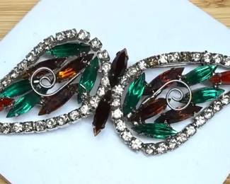 Rhinestone brooch with a silvertone setting and multicolored stones.
