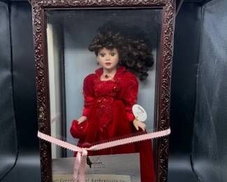 Camellia Garden collector doll in display case. https://modestlambestatesales.hibid.com/