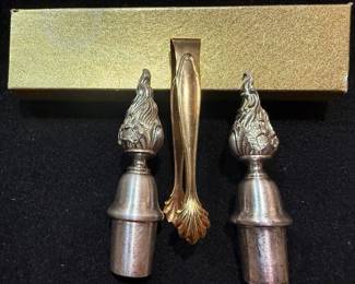 Flame finials. Gold tone tongs. https://modestlambestatesales.hibid.com/