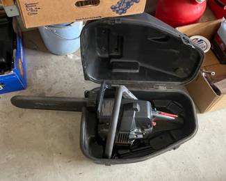 Craftsman Chainsaw in Case and Stack of Steel Wheels