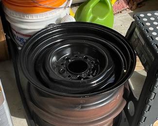 Craftsman Chainsaw in Case and Stack of Steel Wheels