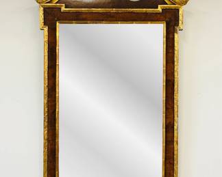 A stunning late 18th century George III era walnut parcel-gilt mirror of rectangular form with a broken pediment embellished with rosettes centering a crest above figured mahogany veneer with gilt surround framing a rectangular plate above shell and acanthus leaf scroll; measuring 56" H x 32" W.
