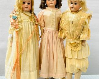 A 23" Antique Armand Marseille 370 doll wearing a long cream color dress and lacy ribboned cap, a 24" Armand Marseille 370 bisque head doll in antique dress, blonde wig, and wearing a small pendant necklace