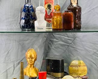 An antique or vintage cobalt blue glass decanter with a sterling silver overlay and stopper, and vintage and antique glass bottles including Field's Blue-Black Ink bottle and vintage Das Feine Hofmark beer bottle; a  a vintage porcelain Schering Trilafon (perphenazine) phrenology bust pharmaceutical promotion piece, three vintage miniature brass maritime spyglasses, and more collectibles