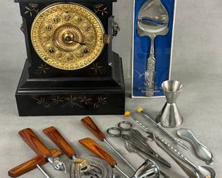 An antique 1880's Ansonia gold metal face mantel clock (with winding key), a Konge Tinn Norwegian pewter cheese slicer with a Viking design handle in original box, a 5-piece bar set including corkscrew, bottle opener, strainer, and jigger/shot glass; vintage silver or silver plate sugar tongs, scissors, and cocktail spoon