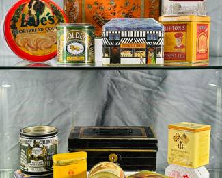Vintage, replica and modern lidded tin canisters, boxes with advertising including  Blanke's Saratoga Coffee, Bon Ami, Heinz's Blackberry Jelly, Lyle's Golden Syrup, Lipton Tea, The Movie Channel, and more.