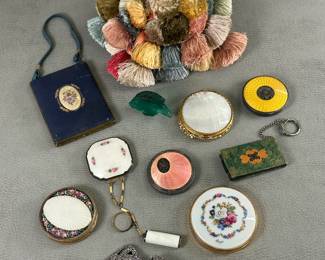 A Lalique France crystal miniature angel fish sculpture, a collection of vintage cosmetic compacts, a vintage French tassel furniture key fob in shades of green, pink, gold, beige, red, and cream; antique French cut metal and black leather shoe buckles stamped M. G. France  