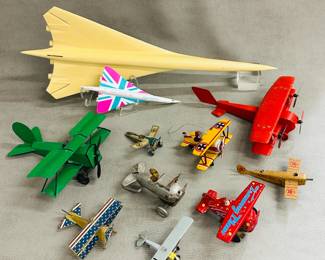 Antique and vintage toy airplanes including a vintage 1930s tin wind up aero stunt plane, a vintage wind up toy training plane, a Corgi London 2012 Olympics 'British Classics' TY84005 GBC Range Concorde