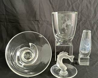 A signed Steuben crystal bowl, an Art Deco Swedish crystal glass vase with engraved cupid shooting an arrow, designed by Emil Weidlich for Värends Konstglas, a Lalique crystal "Goujon" or "Poisson" leaping koi fish ring or pin dish, an Orrefors clear glass bud with engraved bird and branch motif designed by Sven Palmqvist