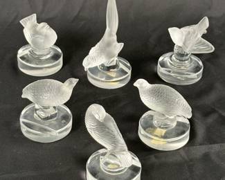 A selection of six vintage Lalique frosted crystal place card holders including Perdrix (partridge or quail), pheasant, Tourterelle (turtle dove), a pheasant, and sparrows
