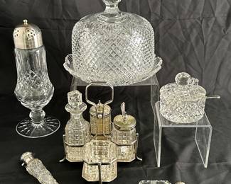 Antique c. 1890 American Brilliant cut glass cheese dome with matching tray, a Waterford Crystal Lismore sugar shaker with silverplate lid, an antique cut crystal "laydown" perfume or scent bottle with a sterling silver hinged cap, an antique silver-plated and cut-glass cruet set, a cut glass salt cellar with silver spoon, and a vintage American Brilliant Cut Glass lidded condiment jar with spoonn
