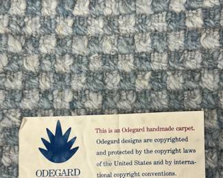 Closeup of the 9’ x 12’ Odegard handmade carpet in a fine checkerboard pattern.