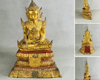 A Thai gilt bronze Buddha statue – the Buddha is depicted wearing lavish, ornate courtly robes with jewelry and a tall, winged crown, and is seated in the bhumisparsa mudra (earth-touching gesture) on a three-tiered base painted with red and black lacquer. With purchase card from Marshall Field & Company dating it to 18th Century.
