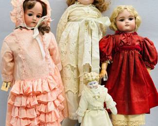 Antique dolls including a 22" German bisque head doll wearing a frilly bonnet and dress, a German antique Max Handwerck 2-1/3 bisque head doll, 23 inches tall, brown sleep eyes, red dress, ribbon laces shoes, marked back of head with "Made in Germany Max Handwerck 2-1/3"; and a small China head blond doll in cream color dress with lace accents 