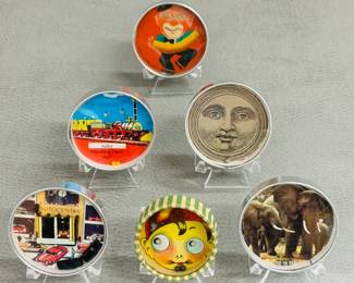 Vintage dexterity puzzles featuring various decorative scenes including a clown, a vintage German train, an old car dealership, a face of the moon, elephants, and a child's face. 
