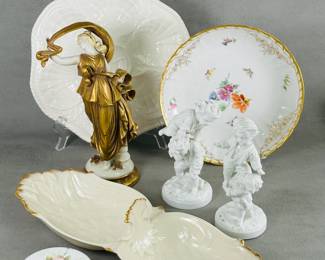 A porcelain serving dish with impressed seashell pattern, a vintage Capodimonte porcelain figure of a dancer, a Crown Derby porcelain round lidded box with enameled floral decoration, a pair of white porcelain figurines (likely European) depicting two boys playing together, and a Lenox Newport Collection 2-compartment relish dish