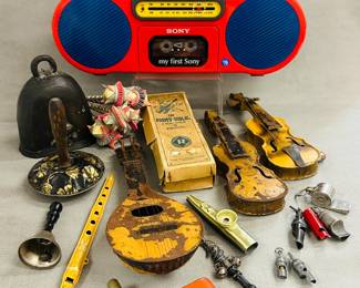 Vintage musical toys and noisemakers including a My First Sony CFS-2020 boombox, whistles, tin flute, violins, and more