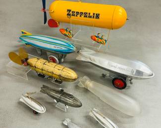 Collection of vintage toy zeppelins including a Tucher & Walther litho tin zeppelin toy, and a Schylling Collector Series wind up Graf zeppelin toy